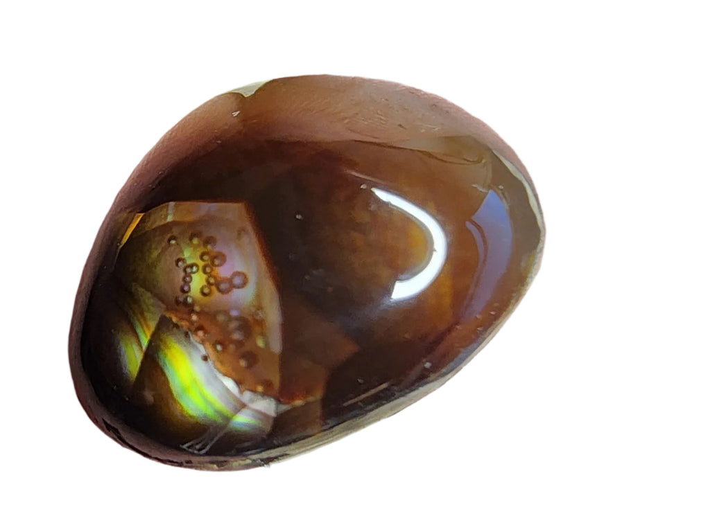 a polished brown gemstone with iridescent green and yellow flashes