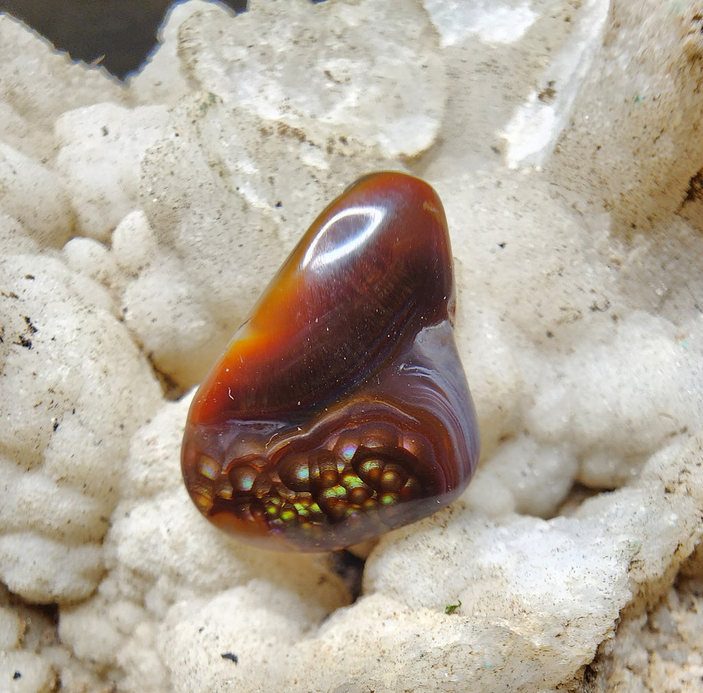 Fire agate cabochon with natural chalcedony banding and botryoidal fire cluster, 11.11 carats