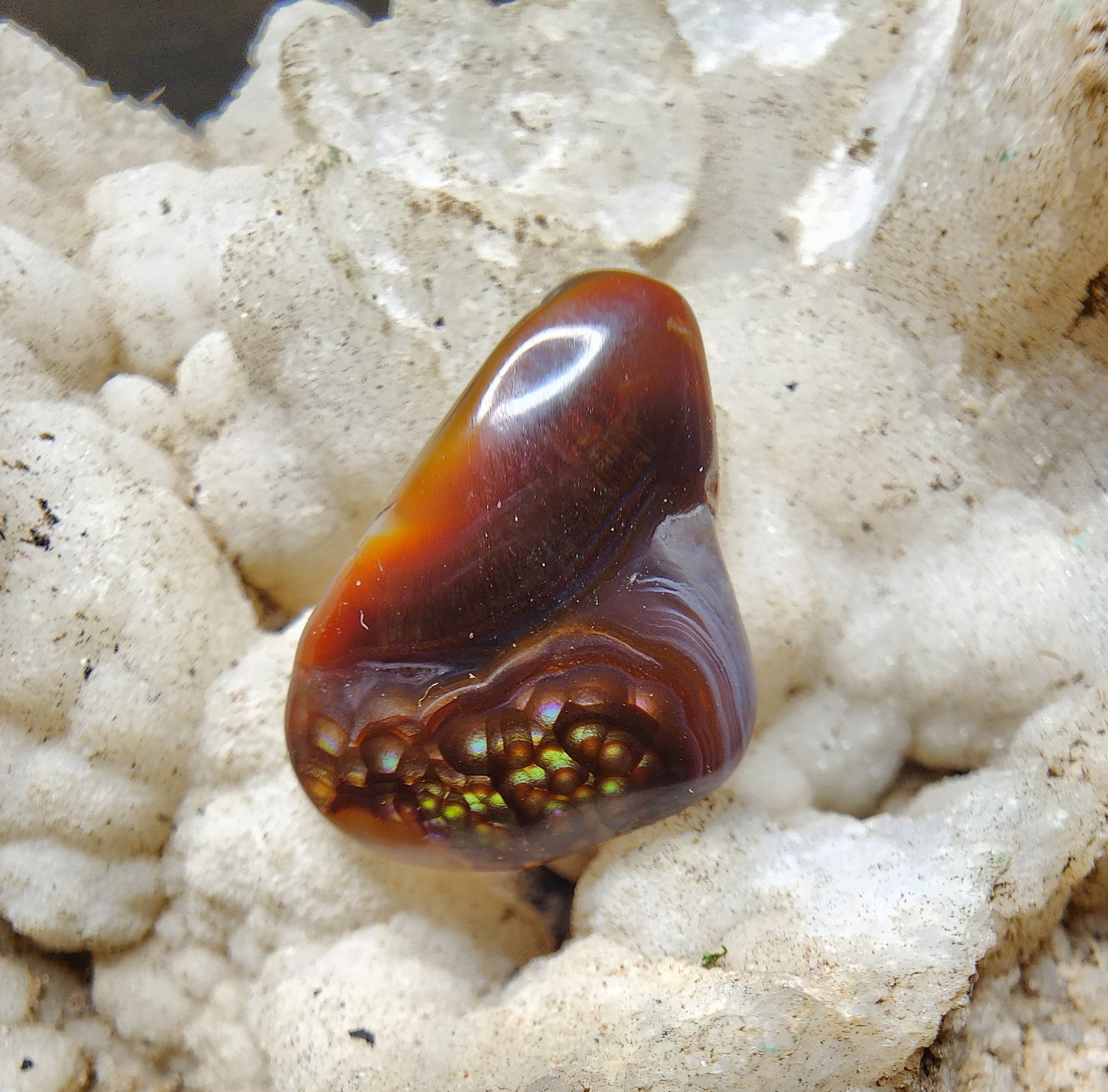 Fire agate cabochon with natural chalcedony banding and botryoidal fire cluster, 11.11 carats