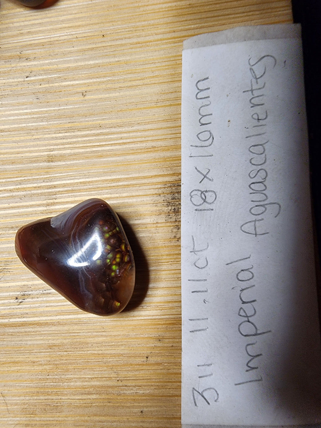 Fire agate cabochon with natural chalcedony banding and botryoidal fire cluster, 11.11 carats